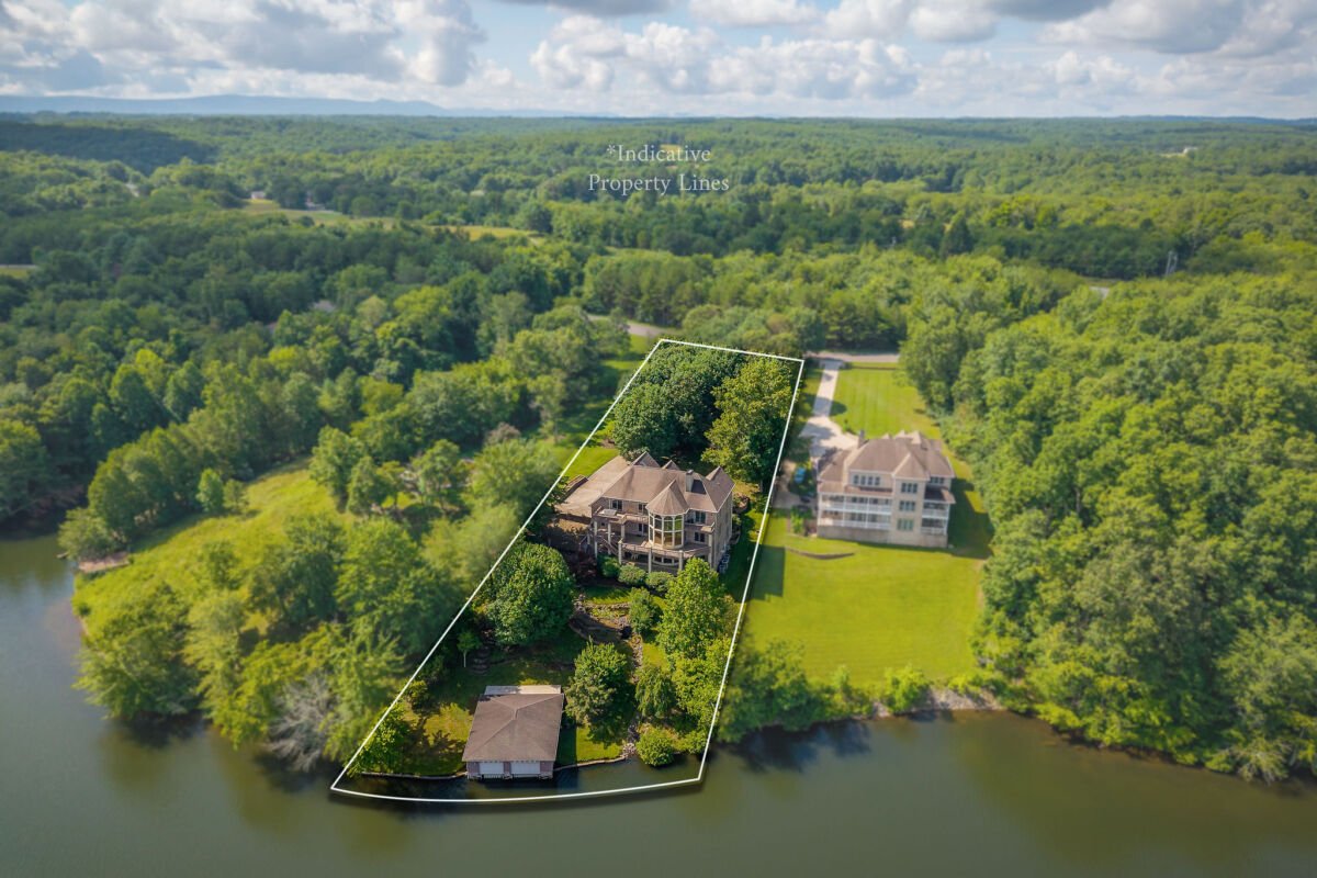 Lake Home & 1.1+/- Acres • 2 Slip Boathouse • 6,000 sq/ft • Holiday Lake Access • Personal Property