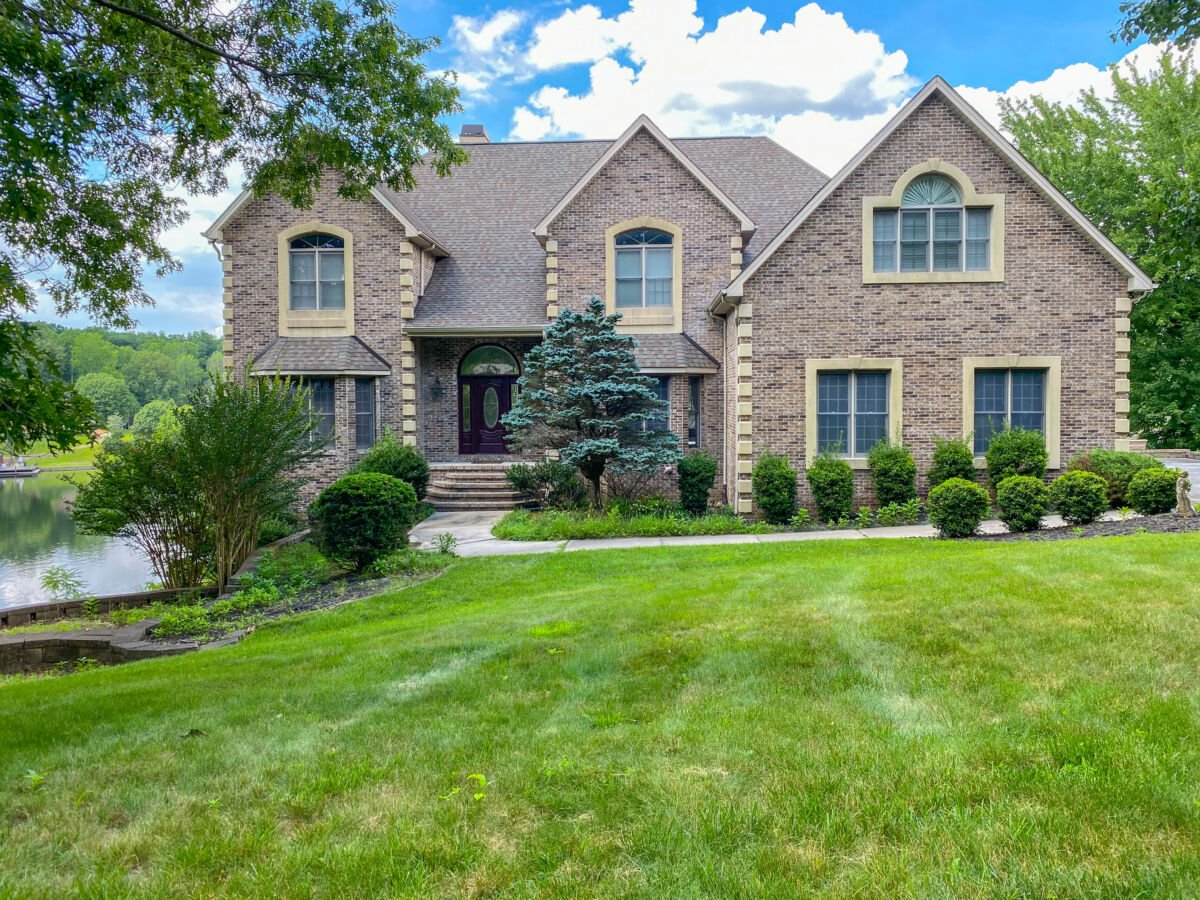 Lake Home & 1.1+/- Acres • 2 Slip Boathouse • 6,000 sq/ft • Holiday Lake Access • Personal Property